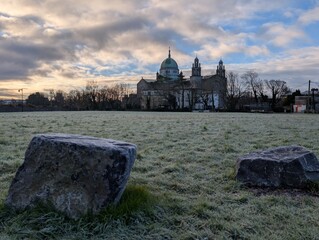 Galway Cathedral Irish Landmark Architecture with Green Dome and Stone Towers Under Blue Sky and Frosty Morning Grass in Ireland
