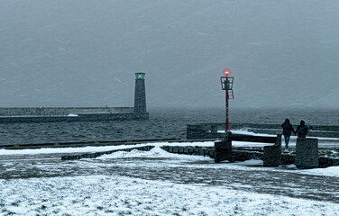 Cold winter weather in Europe. Lighthouse and pier in Gdynia
