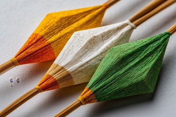 Vibrant saffron paper kite patang being prepared for flying in the afternoon sun on a lively Indian street