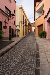 Fototapeta premium Quiet cobblestone street with colorful houses and lanterns in La Orotava, traditional old town architecture, Tenerife, Canary Islands.