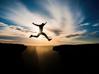 A silhouetted figure joyfully leaps across a gap at sunset s edge