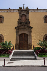 San Agustin Church facade with baroque stone portal and wooden door, historic architecture in La Orotava, Tenerife, Canary Islands.