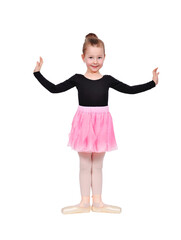 Happy young girl standing in ballet pose wearing pink tutu.