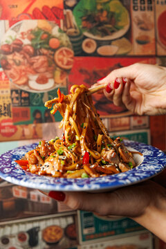 Explore a mix of dishes from different cuisines featuring noodles and vegetables in a vibrant setting