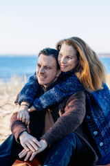 Portrait happy beautiful couple in love enjoying autumn picnic in autumn park. Vertical photo. High quality photo