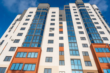 Fototapeta premium Modern Apartment Buildings with Colorful Facades and Glass Windows in Contemporary Urban Residential Area