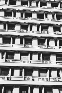 schwarz-wei&szlig; aufnahme eines geb&auml;udes von unten, fenster, und fassade sind gut sichtbar. der himmel ausgegraut.