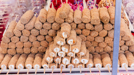 Window display of a marshmallow shop near Coney Island attractions on a winter day