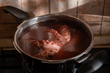 Boiled octopus cooking in stainless steel pot