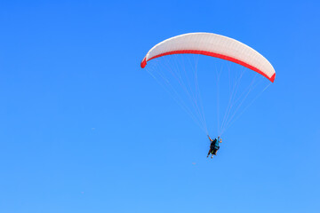 Paraglider soaring in clear blue sky adventure freedom