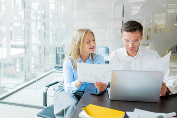Two people review data in a modern office setting
