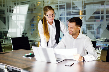 Team members discuss work at a meeting table
