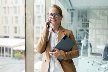 Professional woman talking on the phone in office
