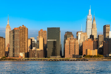 A beautiful view of the Midtown Manhattan skyline with iconic buildings at sunrise.