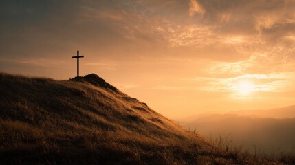 CROSS ON A HILL AT SUNSET