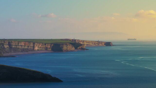 Aerial drone View of of Jurassic coast in the distance and Nash Point lighthouse. Ogmore South Wales uk