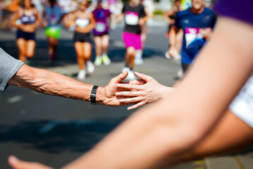 Clap hands of a senior runner and young fan at marathon