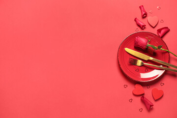 Beautiful table setting for Valentine's Day with rose flower and decorative hearts on red background