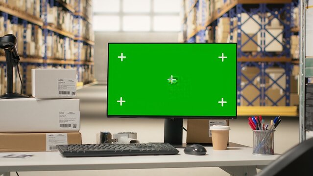 Industrial storage room with mockup chroma key on a computer, space featuring shelves, barcode scanners and packaging materials for order fulfillment. Large scale e-commerce shipment.