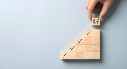 hand placing wooden block with target on top of staircase