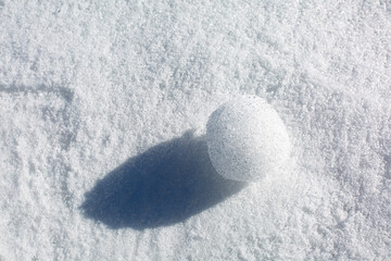 Snowball on a white snow. Background.