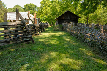 Stacked timber and woven fencing in rural field in South Carolina