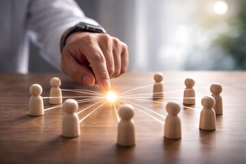 Businessman connecting wooden people figures with a light beam for team building, networking and human resources concept.