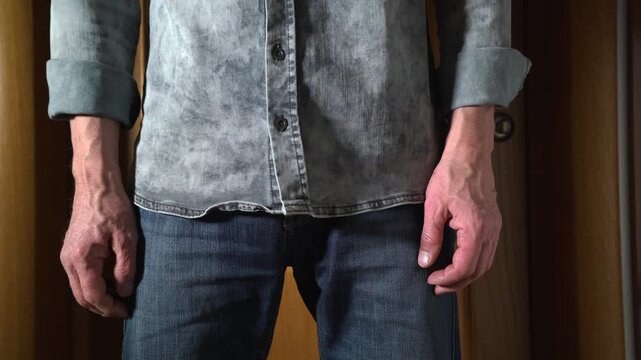 Unrecognizable middle-aged man scratching his crotch due to itching and discomfort in the groin area. 4K