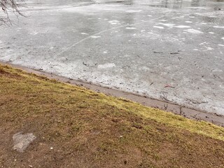 Icy Coastal Landscape, Bitter Cold Shoreline With Ice Formations And Green Algae Present, Stark Winter Scene Along Cold Coast Showing Icy Terrain And Aquatic Algae In Frozen Waters