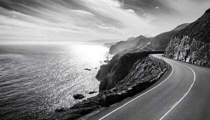 Coastal Road Winding Along Rugged Cliffs With Ocean Waves At Night