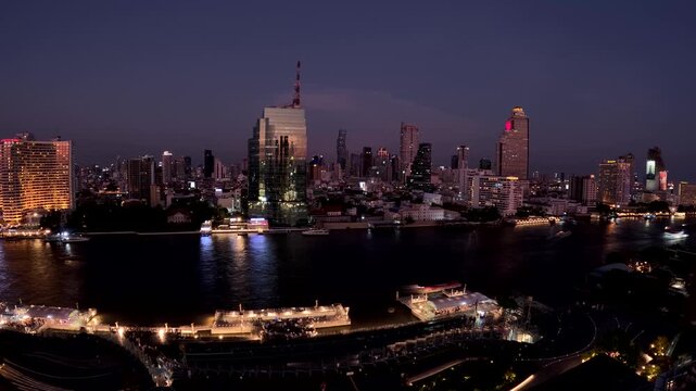 Bangkok Skyline Timelapse with Boats on Chao Phraya River at Night