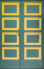 Fototapeta premium Green doors with yellow square panels in bold facade. Colorful geometric doorway.