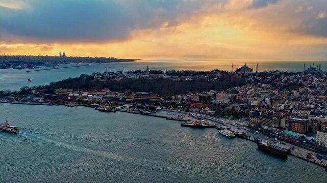 Drone footage showing Sarayburnu, Topkapi Palace, Hagia Sophia, the Blue Mosque and the Marmara Sea, all illuminated by dramatic sunset colors over Istanbul&rsquo;s historic peninsula.