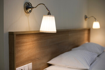 
Beautiful bedroom in beige and brown colours with electric lamps