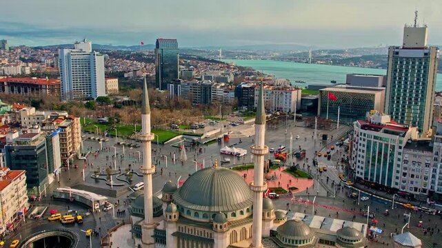 Drone footage showing Taksim Square, Taksim Mosque, surrounding modern buildings, and the Bosphorus, capturing Istanbul&rsquo;s vibrant urban atmosphere from a high-angle perspective.