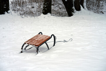 Traditional wooden sled on deep white snow in winter