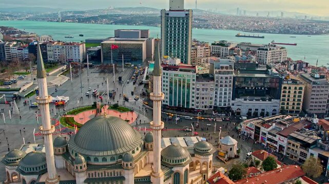 Drone footage showing Taksim Square, Taksim Mosque, surrounding modern buildings, and the Bosphorus, capturing Istanbul&rsquo;s vibrant urban atmosphere from a high-angle perspective.