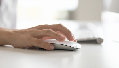 Human hand using a computer mouse on a clean desk, highlighting the importance of ergonomics and technology in modern office settings. 