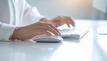 Focused shot of hands on a keyboard and mouse, suggesting technology and work