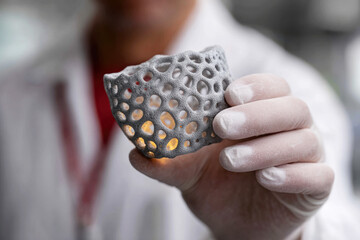Scientist Hand Holding Gray 3D Printed Lattice Structure Object with Organic Geometric Pattern
