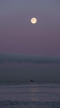 Salish Sea Full Moon vertical video 4K UHD.The full moon over the Fraser River and Salish Sea in Richmond, British Columbia, Canada. 4K, UHD.
