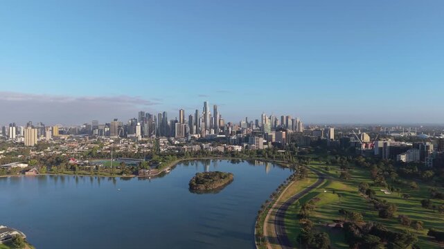 Aerial Push In Toward Melbourne CBD Skyline Across Albert Park Lake