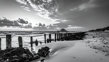 Monochrome Beachscape - Wooden Groynes and Dramatic Sky at the Coast.