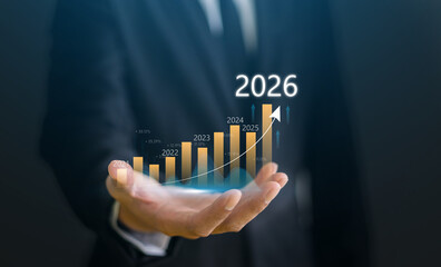 Businessman with digital arrow graph with 2026 year number, business growth, financial plan and strategy for new year 2026, marketing and profit, corporate future success and development concept