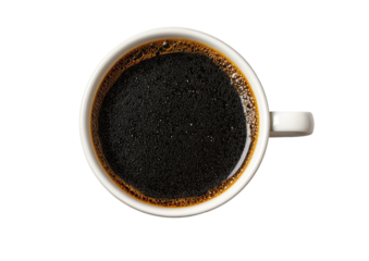 Overhead view of a white mug filled with dark black coffee on black