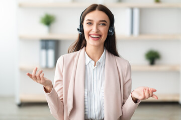 Portrait Of Hotline Operator Woman Wearing Headset Talking And Smiling Looking At Camera Consulting Customer In Office. Online Consultation With Professional Consultant Or Manager Via Video Call