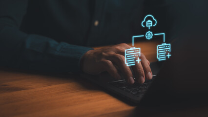 Cloud computing and database management concept. Person using laptop with glowing blue hologram icons of data server, cloud storage, and secure network connection.