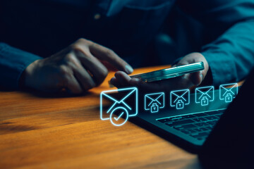 Secure email and cybersecurity concept. Person using smartphone and laptop with glowing blue hologram icons of encrypted messages, verified mail, and digital data protection.