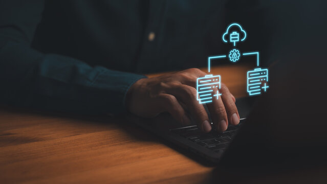 Cloud computing and database management concept. Person using laptop with glowing blue hologram icons of data server, cloud storage, and secure network connection. - Powered by Adobe