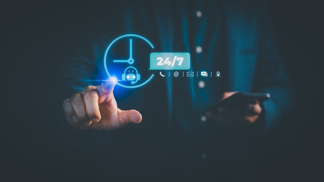 Customer service concept with 24/7 AI chatbot support. Businessman touching virtual clock icon and contact symbols on smartphone for round the clock assistance and communication. - Powered by Adobe